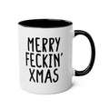 White mug with black interior and handle, featuring the text 'Merry Feckin' Xmas' on a white background.